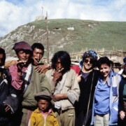 a motley gathering of young Khampa farmers casually pose for their snapshot with visitors, among them Barbara Nimri; Kham, East Sichuan, 1982, China